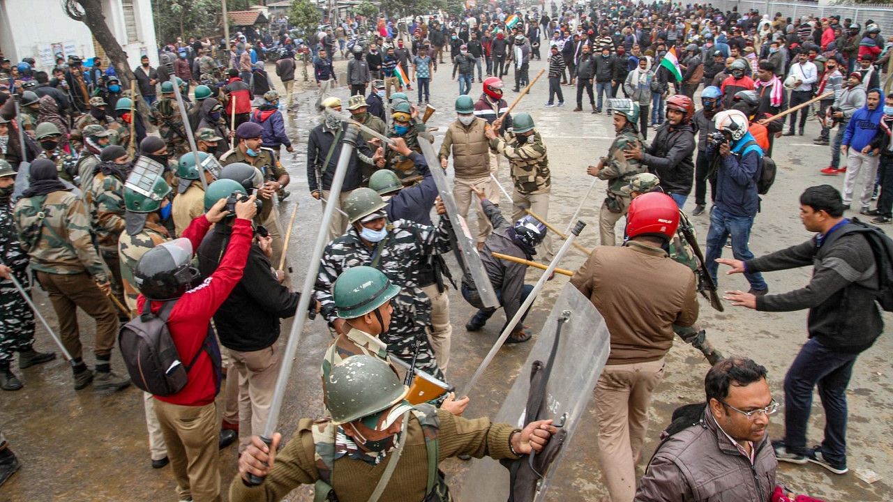 Agartala: Police personnel use tear gas shells on teachers to disperse them during their protest, in Agartala, Wednesday, 27 January 2021. The authorities-imposed restrictions under Section 144 in the city amid the ongoing protest of teachers.