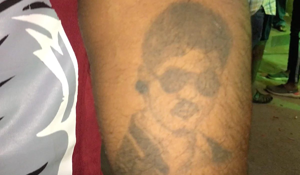 Guru showing off his Vijay tattoo.