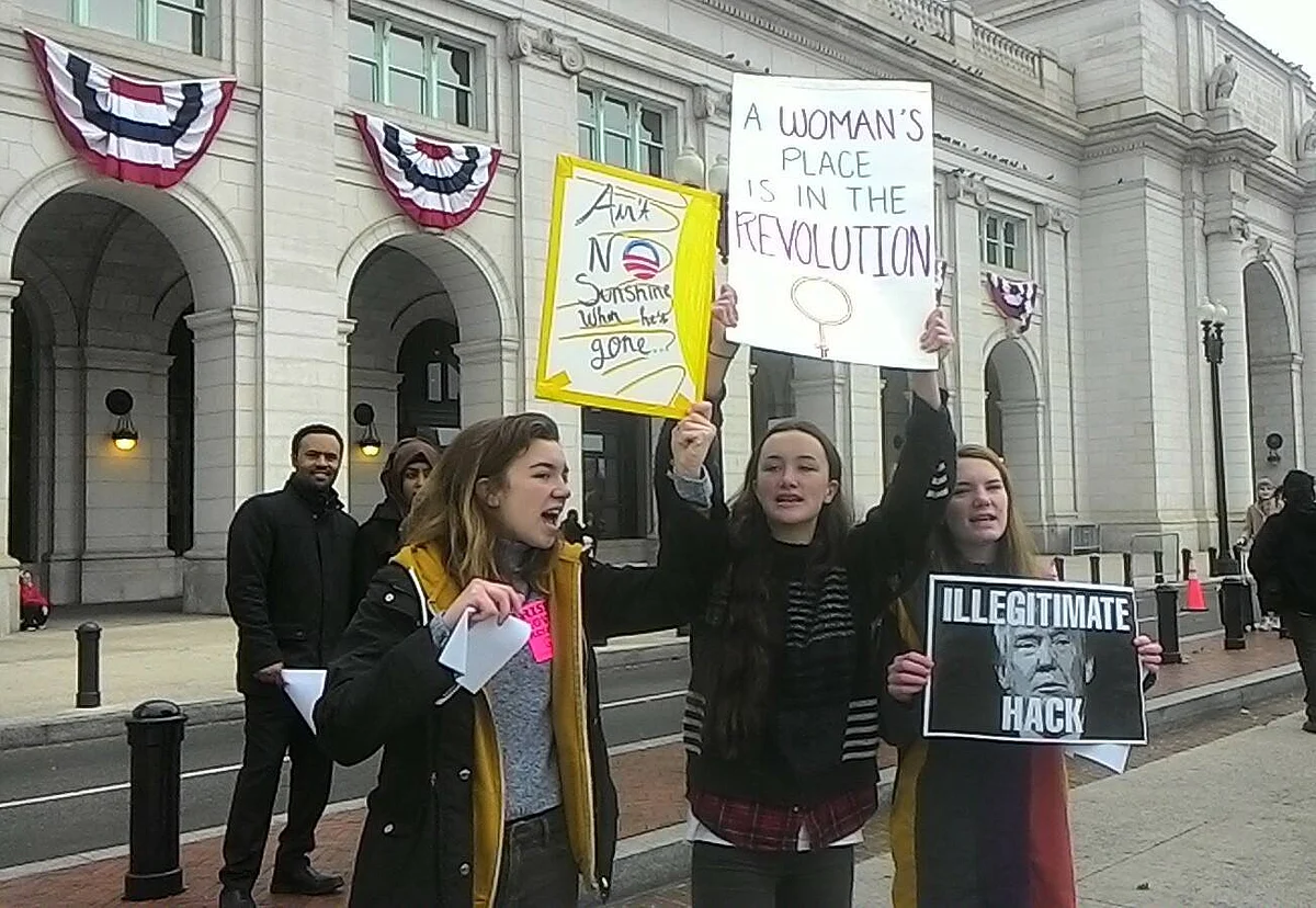 Adriana and her sisters Lantheg, 14, and Mary-Troy, 17, protest outside Union Station from where they marched towards Capitol Hill.