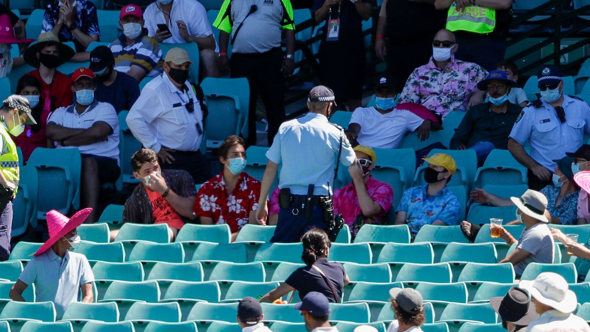 Police talk to spectators as the game is stopped after a complaint by Indian players during Day four of the third  test between India and Australia at the Sydney Cricket Ground.