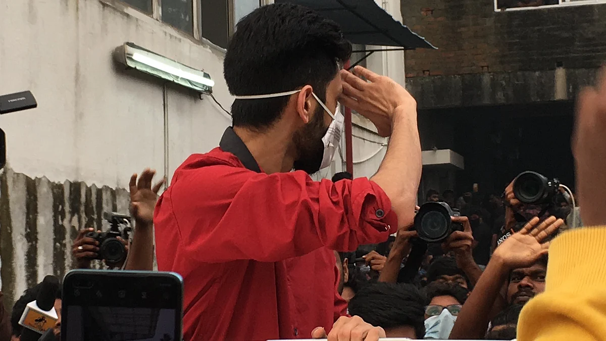 The music director waves to fans.