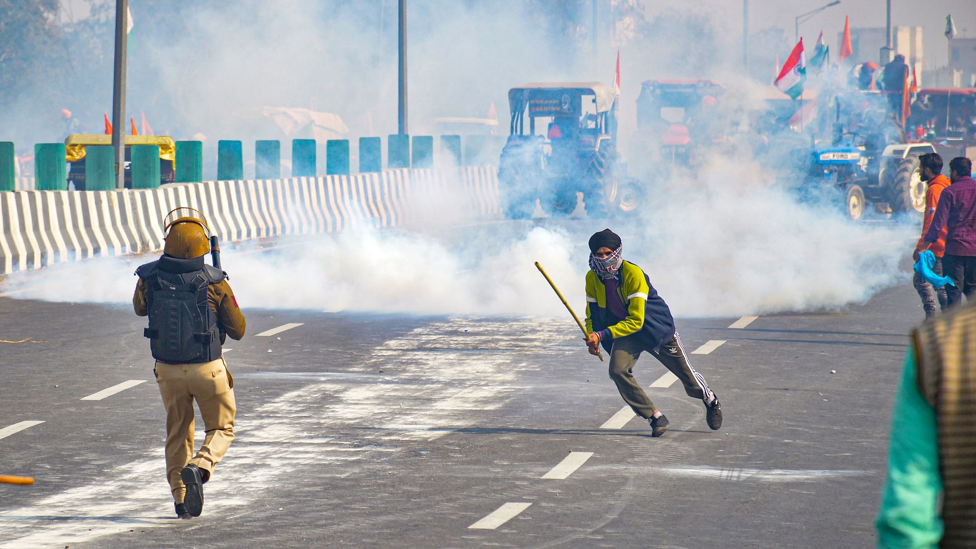 Police fires teargas shells as farmers attempt to march towards Delhi during the Kisan Gantantra Parade amid the 72nd Republic Day celebrations, at Akshardham in New Delhi, Tuesday.