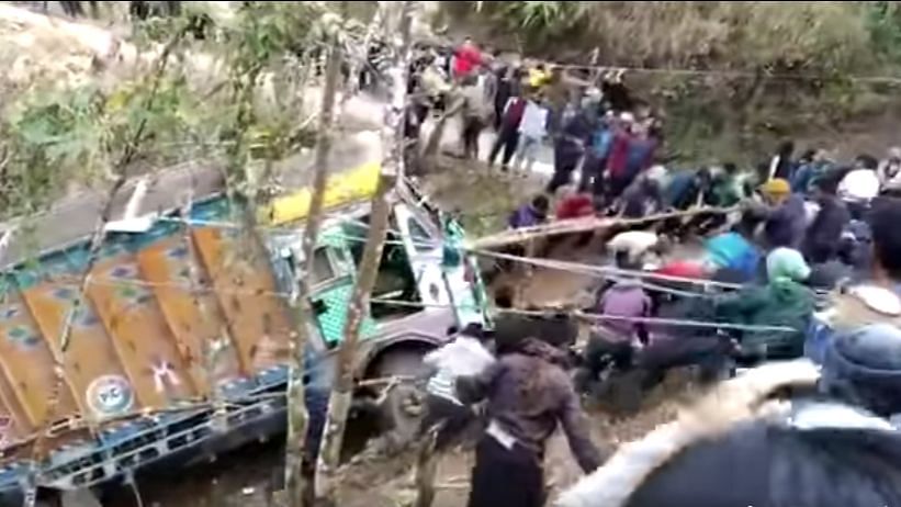 Nagaland villagers pull truck out of gorge. 