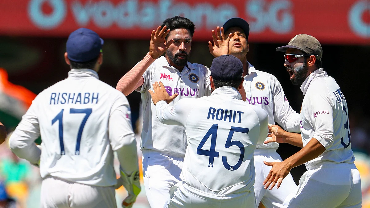 Mohammed Siraj, second left, celebrates with teammates after dismissing Australia’s David Warner.
