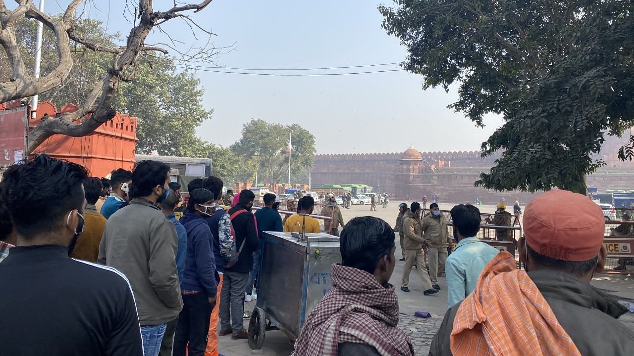 A crowd looks on at Red Fort, a day after clashes between protesting farmers and the police.