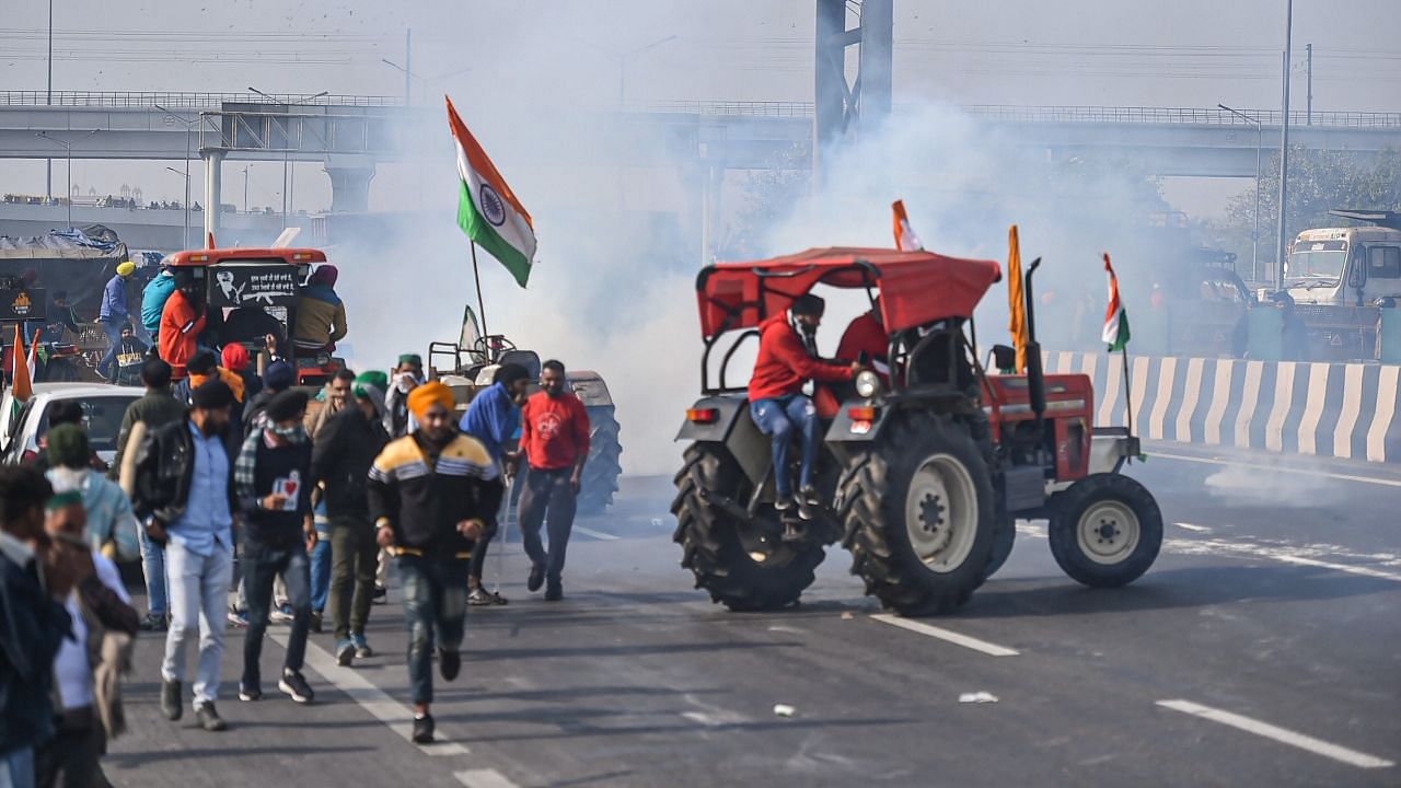 Tear gas was used to disperse farmers attempting to break through barricades at Ghazipur border for the Kisan Gantantra Parade, in protest against the Centre’s farm reform laws, on 26 January, in New Delhi.