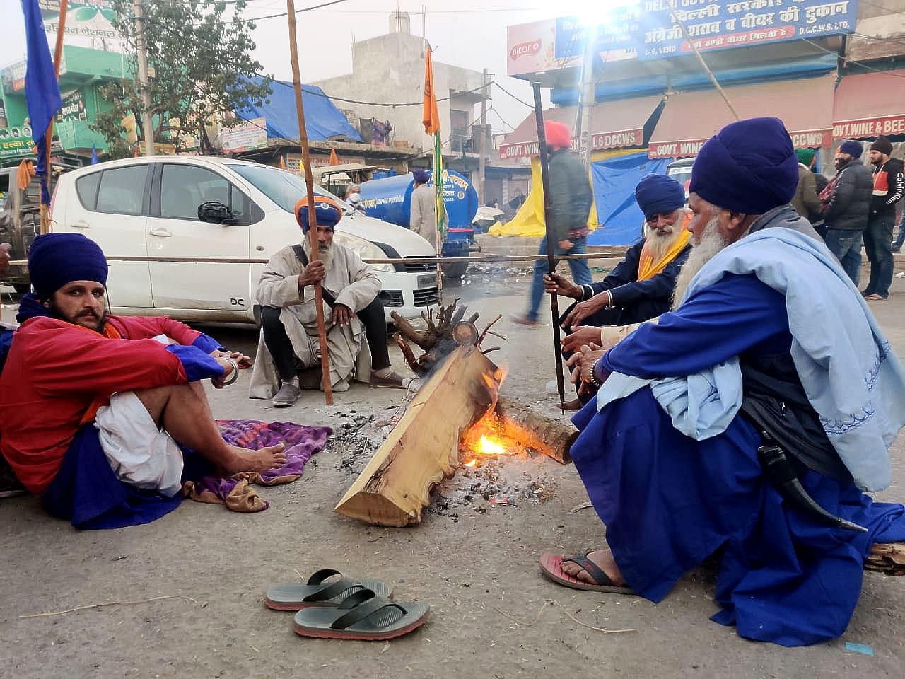 Farmers gather around fire as evening set at Singhu, a day after Republic Day violence.