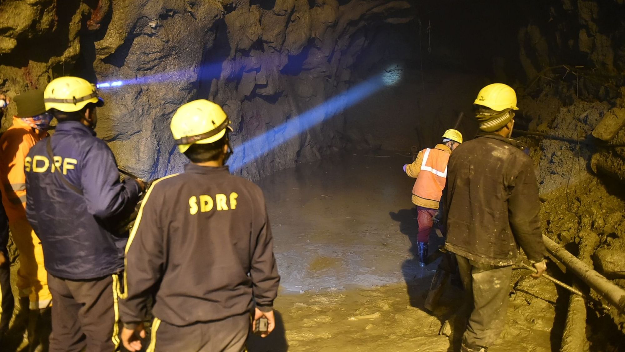 Workers wade through accumulated water during rescue operations inside the Tapovan Tunnel, following the glacier burst at Joshimath which triggered a massive flash flood in Chamoli district of Uttarakhand.