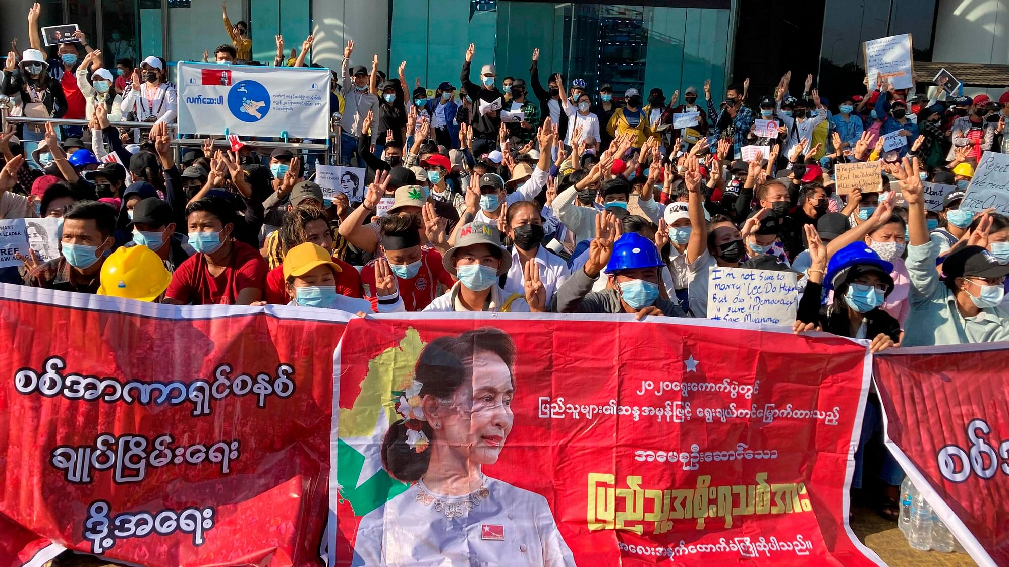 Demonstrators display three-fingered salute, a symbol of resistance at an intersection in Yangon, Myanmar Wednesday, 10 February 2021.&nbsp;
