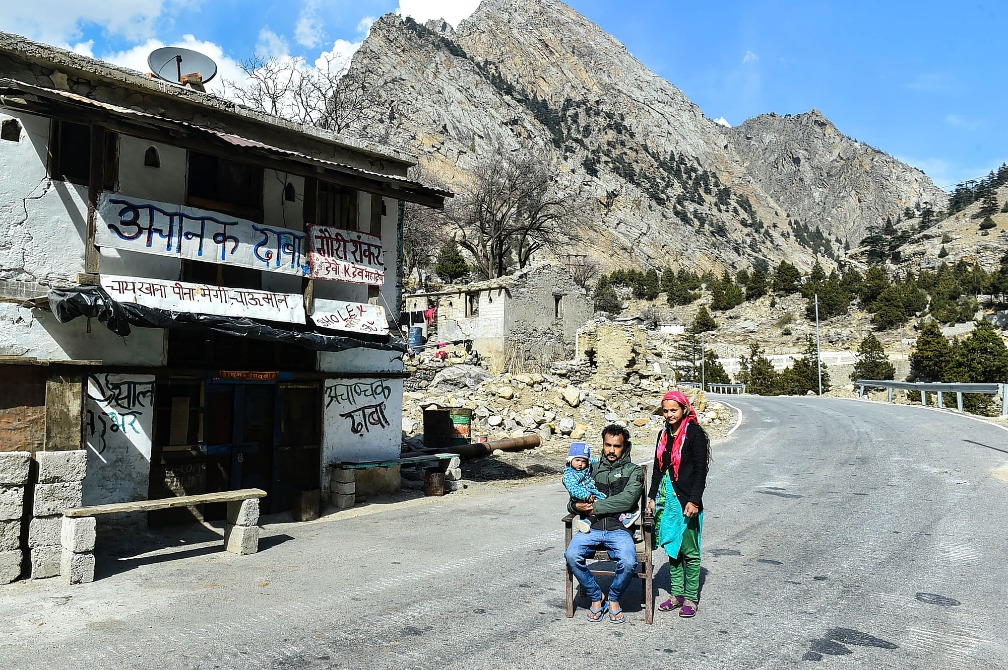 Chamoli: Manish Rawat, 24, along with his wife Laxmi and his daughter Aarohi, pose for photographs near their eatery ‘Achanak Dhaba’, in the aftermath of a glacier burst in Uttarakhand’s Joshimath, at Jumma village in Chamoli district, Monday, 15 February, 2021.