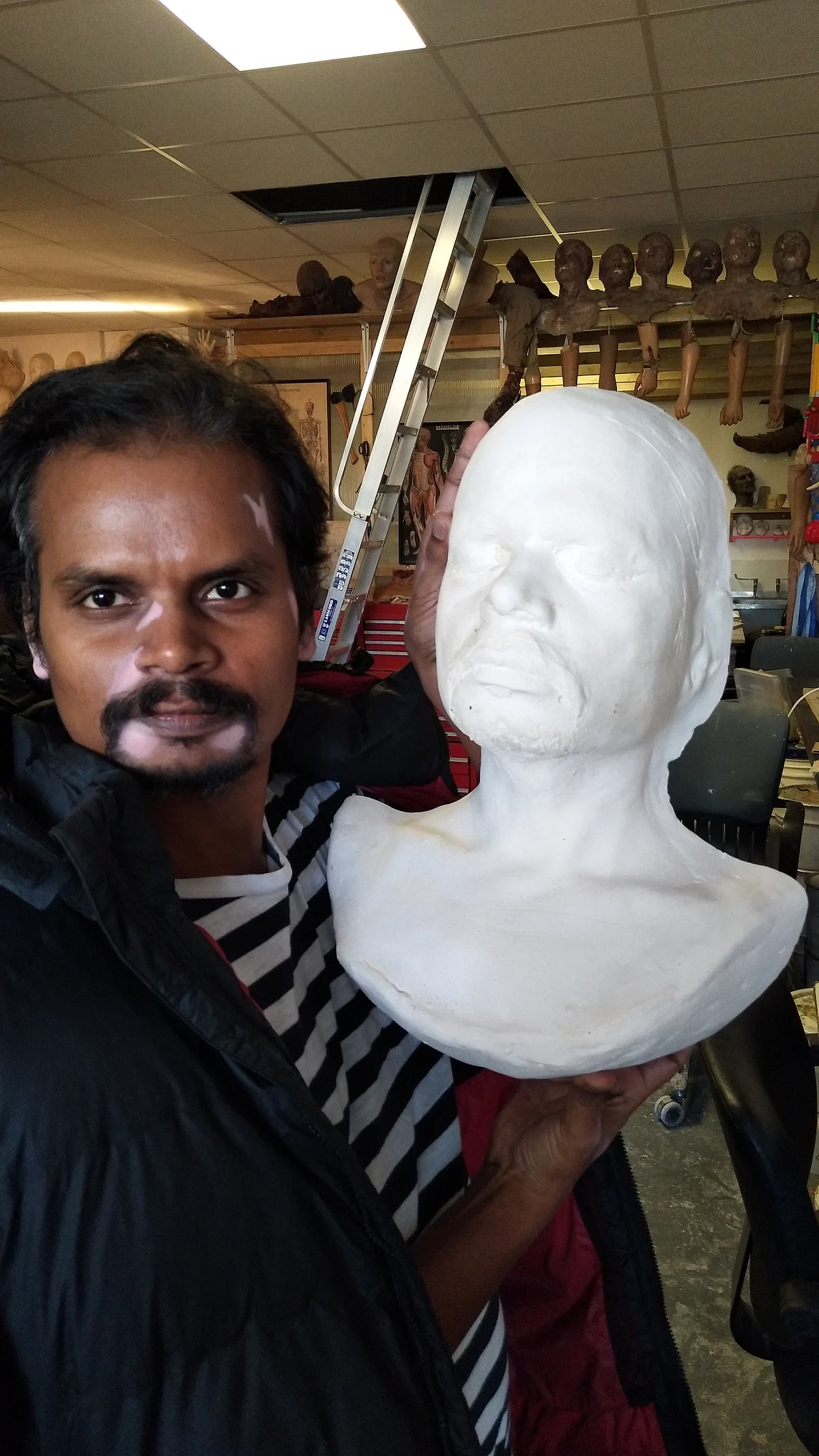 <p>Nalneesh holding the lifecast of his face.</p>