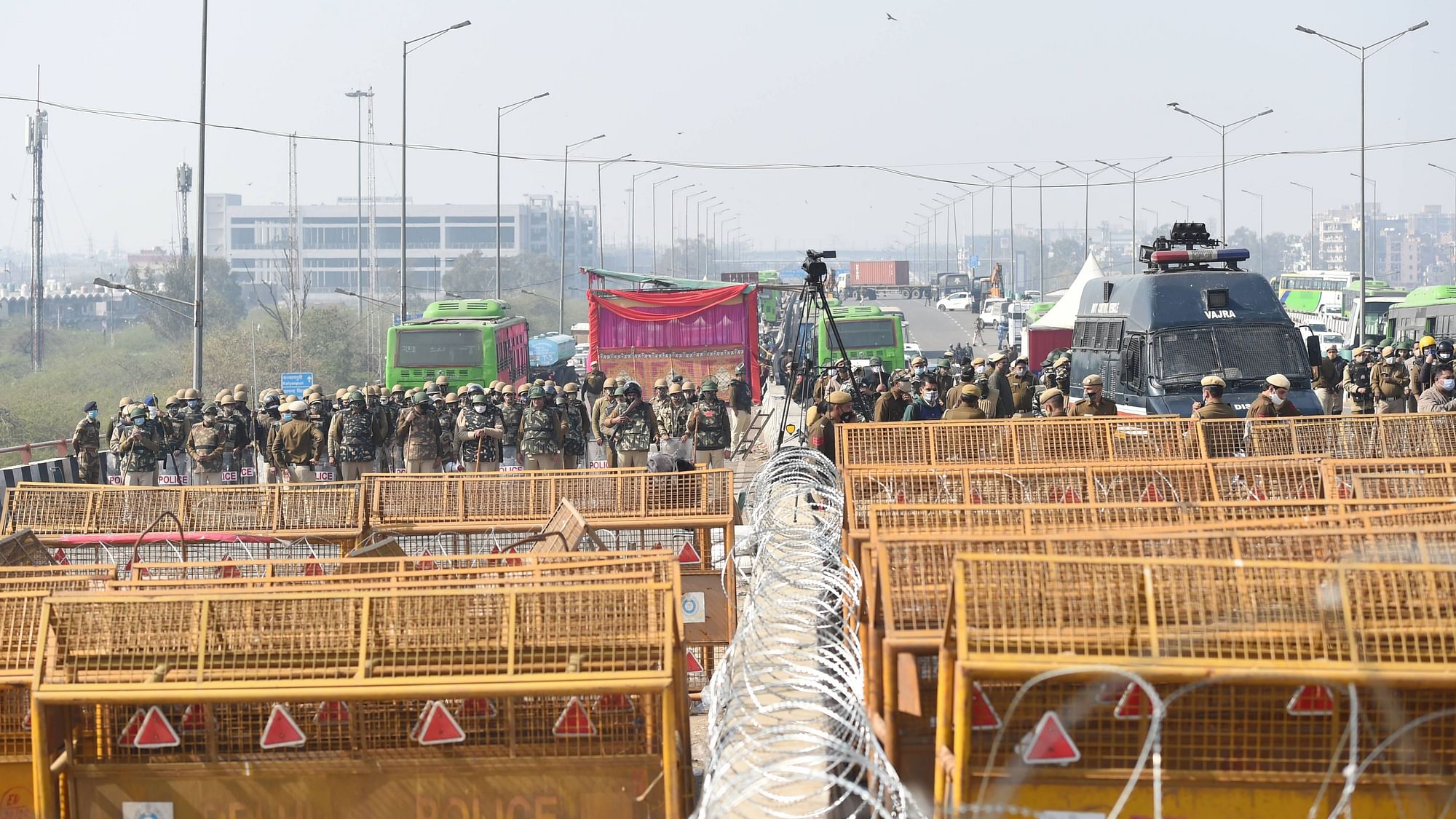 Security personnel stand near barricades ahead of the proposed ‘chakka jam’ by farmers.