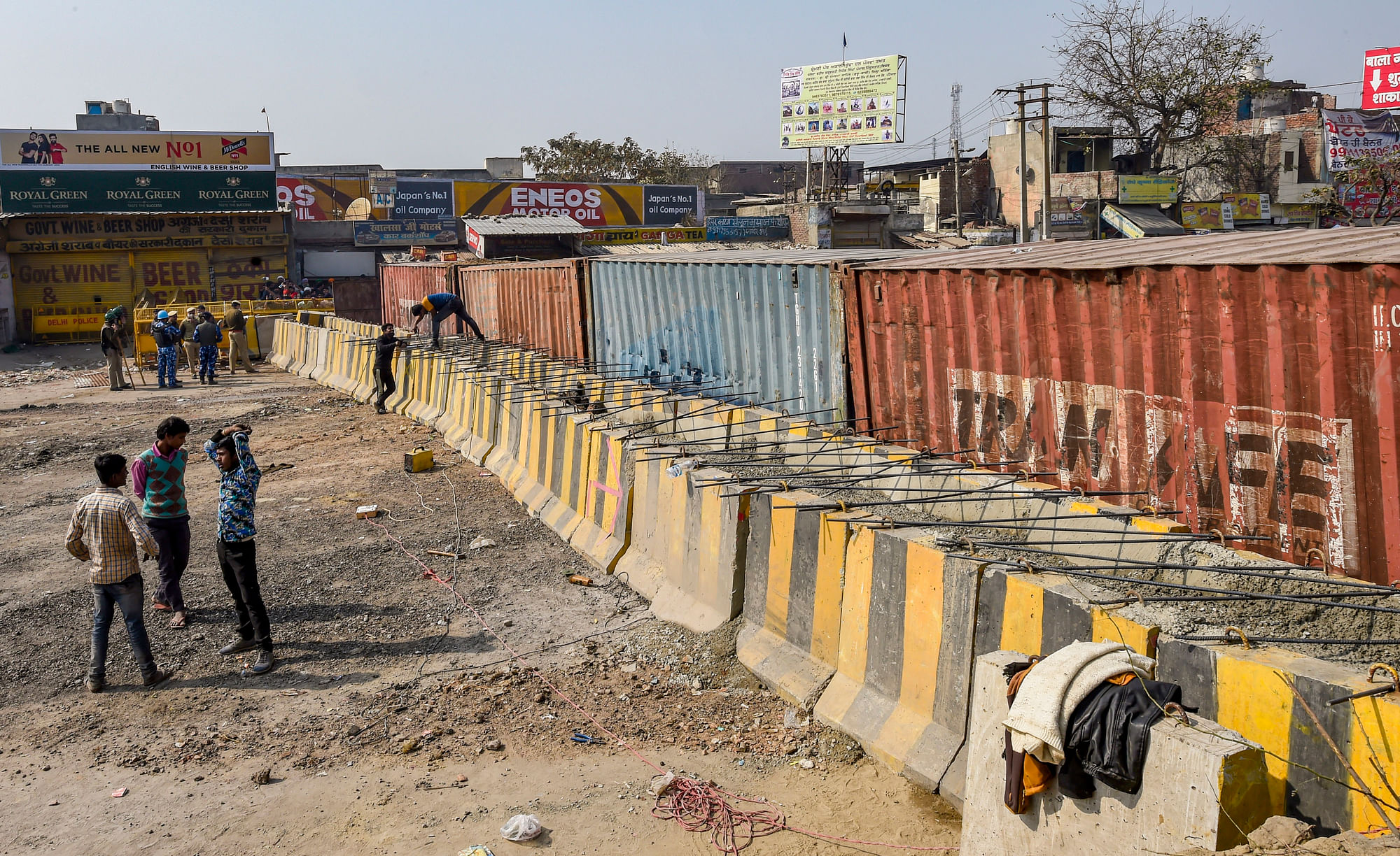 Barricades being set up as part of security enhancements by the police near the site of farmers ongoing protest against farm reform laws, at Singhu Border in New Delhi on Monday.