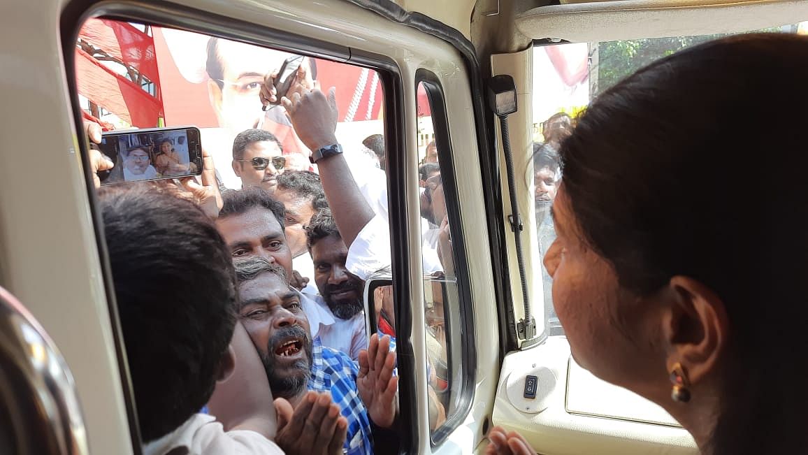 A DMK supporter breaks down in excitement looking at Kanimozhi.