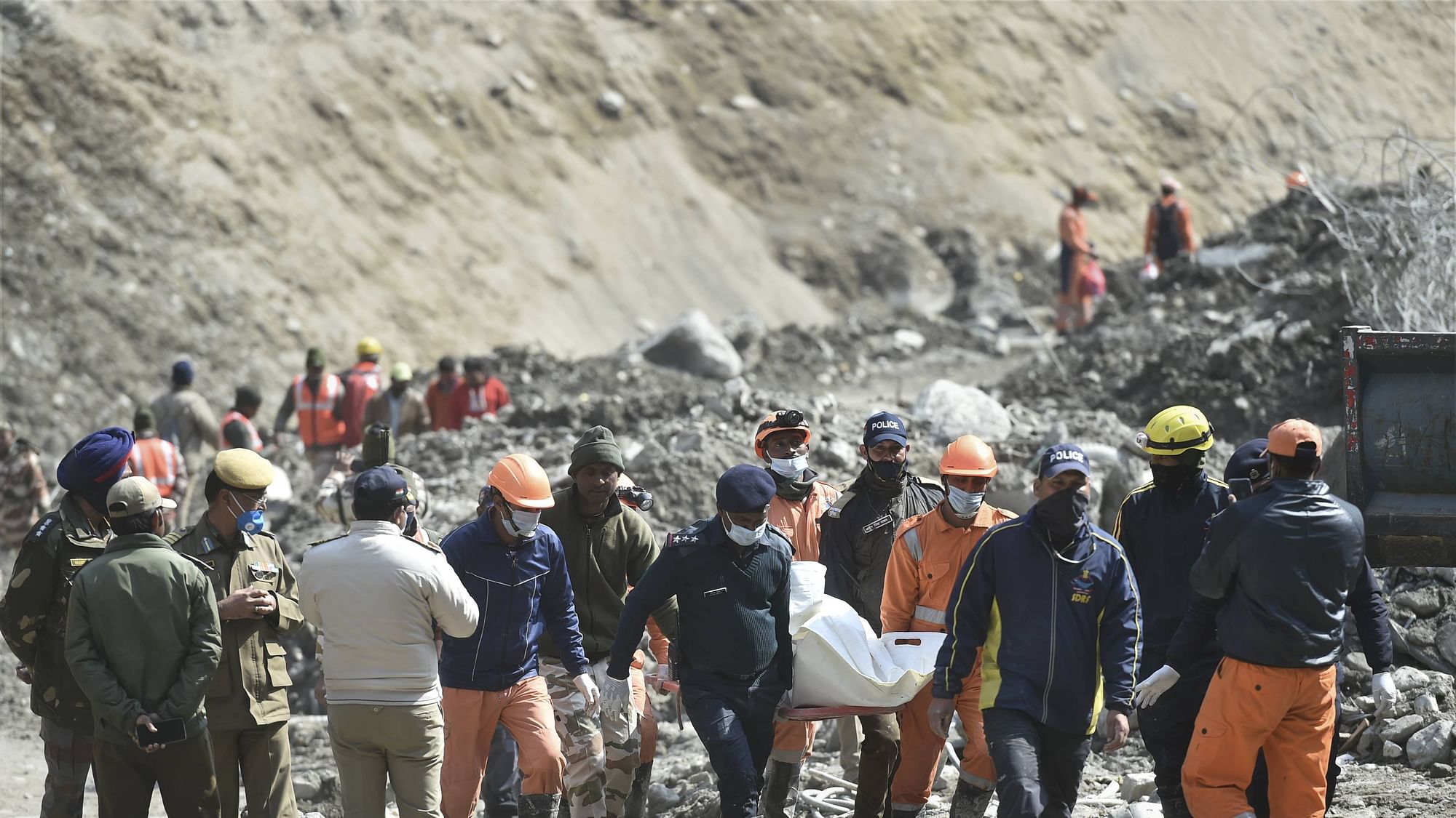 NDRF personnel carry the mortal remains of a flash flood victim near Raini village.