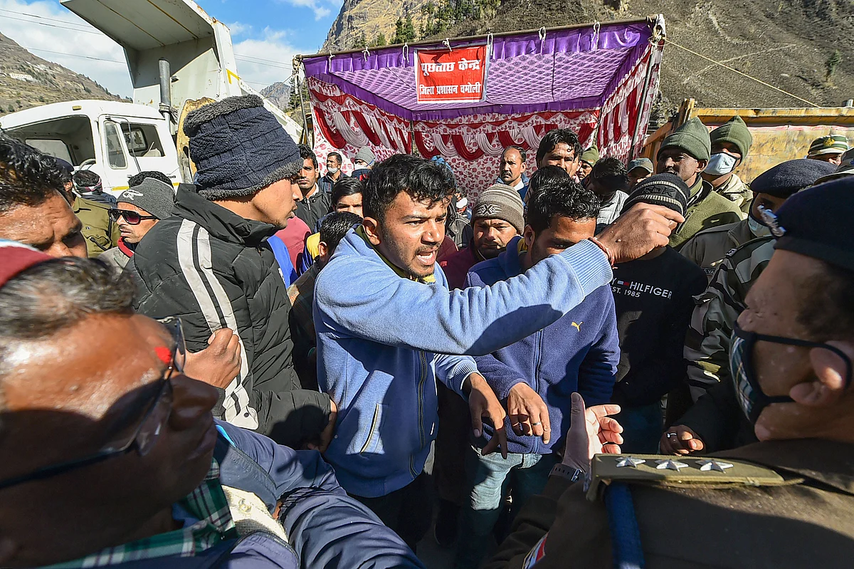 Family members and relatives of missing people get in a verbal spat with officials at a makeshift enquiry centre, near Tapovan Tunnel in Chamoli district of Uttarakhand.