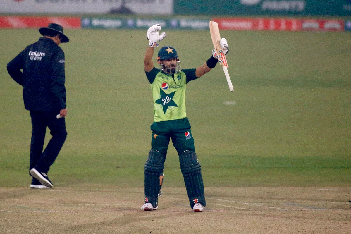 Pakistan’s Mohammad Rizwan, center, raise bat to celebrate his fifty during the 2nd Twenty20 cricket match between Pakistan and South Africa at the Gaddafi Stadium.