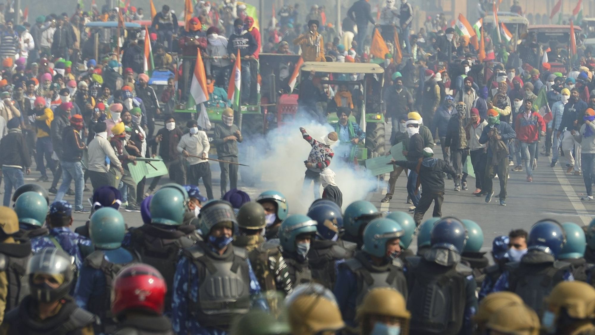 Police uses tear gas to disperse farmers attempting to break barricades at Ghazipur border during their ‘Kisan Gantantra Parade’, on the occasion of 72nd Republic Day.