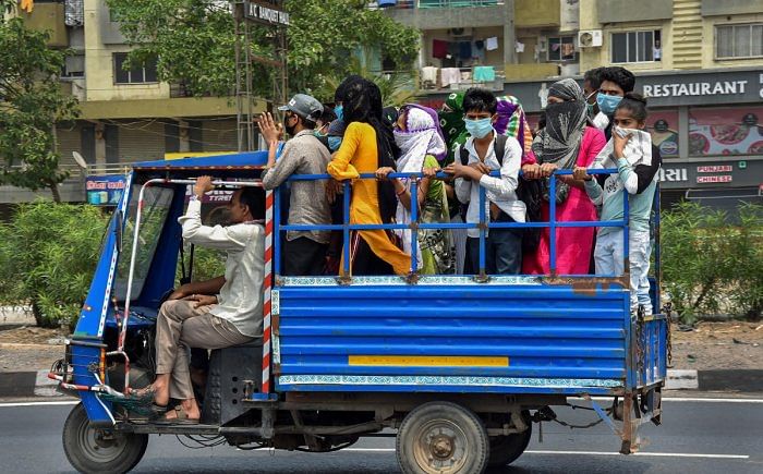 Migrant workers in Surat board a mini-truck to return to their villages on 26 March 2020.