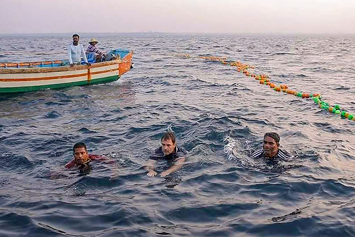 Congress leader Rahul Gandhi (centre) joins fishermen as they work for the morning catch on the high-sea, in Kollam, Wednesday, 24 February, 2021.