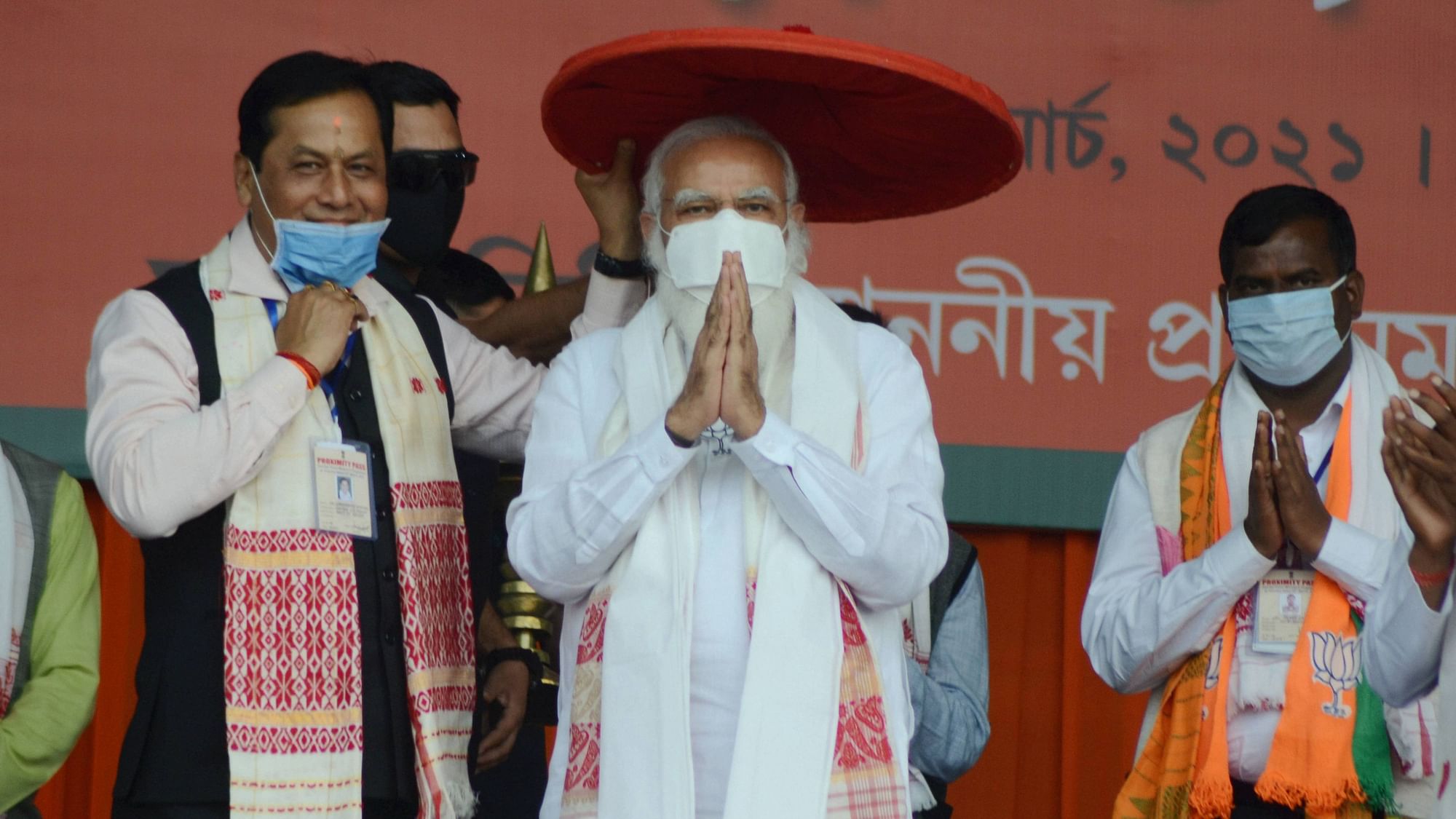 Tinsukia: Prime Minister Narendra Modi being presented an Assamese Japi by Assam Chief Minister Sarbananda Sonowal during a public rally ahead of Assam Assembly polls, in Tinsukia on Saturday, 20 March 2021.