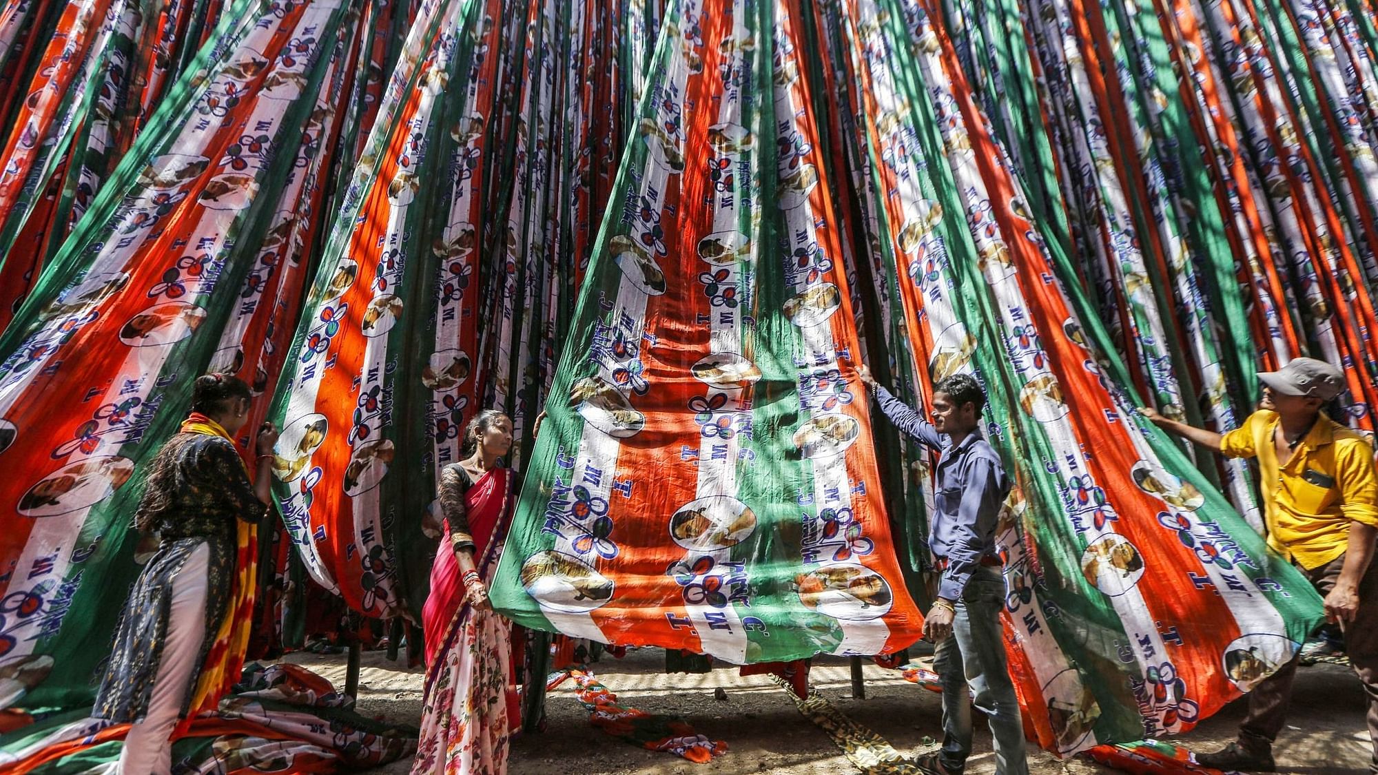 Workers dry roll Trinamool Congress flags after being manufactured at a factory for the upcoming Assembly polls in several states, in Ahmedabad, Wednesday, 10 March.