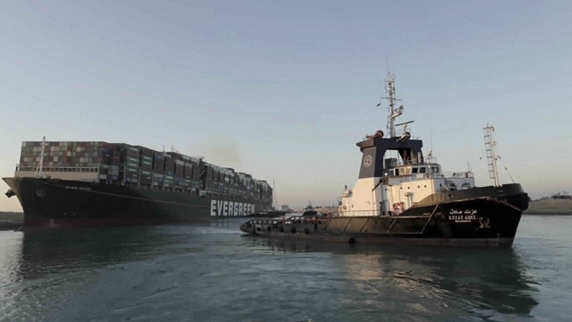 In the photo released by Suez Canal Authority, the Ever Given, a Panama-flagged cargo ship is pulled by one of the Suez Canal tugboats, in the Suez Canal, Egypt on 29 March.