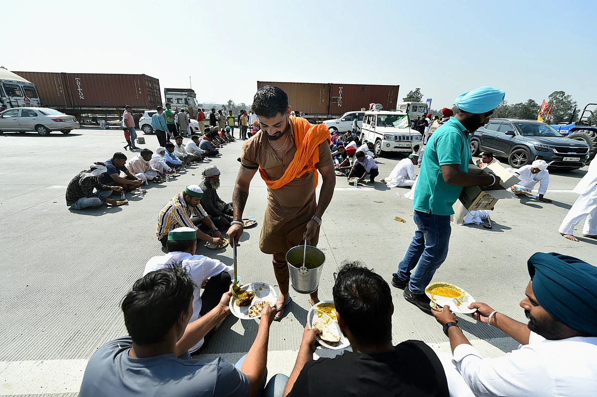 Farmers having their meal as they block the KMP Expressway near Duhai to mark the 100th day of their ongoing agitation against Centres farm reform laws, in Ghaziabad.