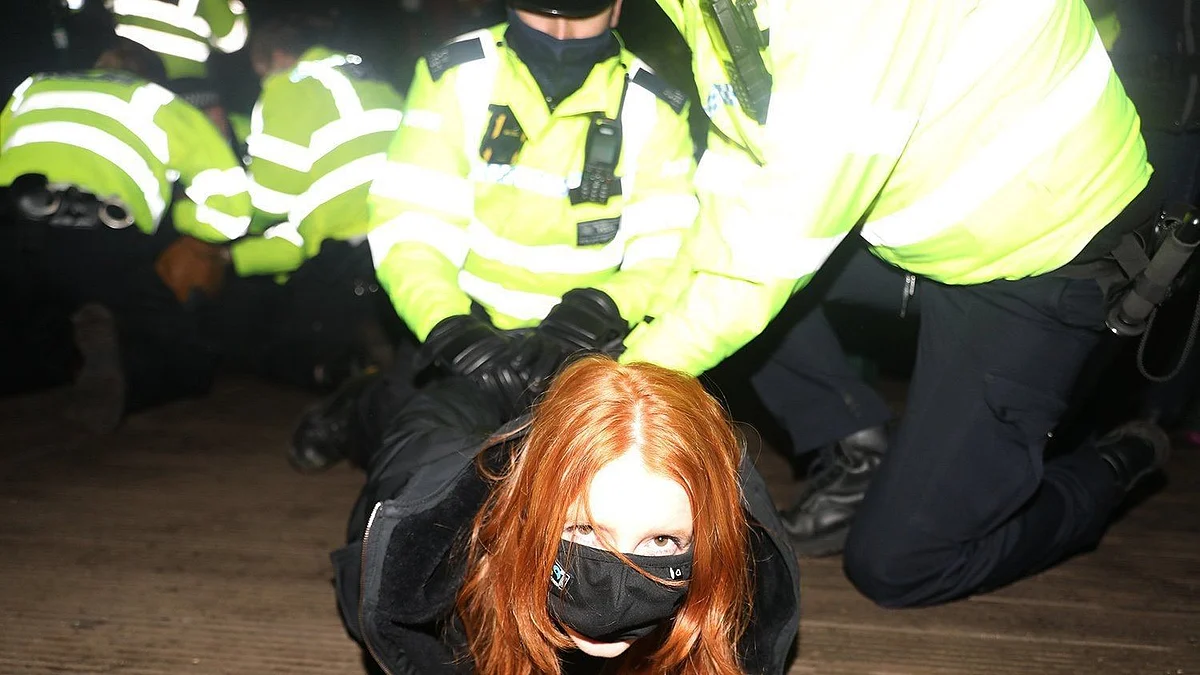 A female protester being handcuffed by the police at the vigil.&nbsp;
