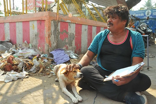 A street dog keeps Mansoor Ali Khan company during his campaign.