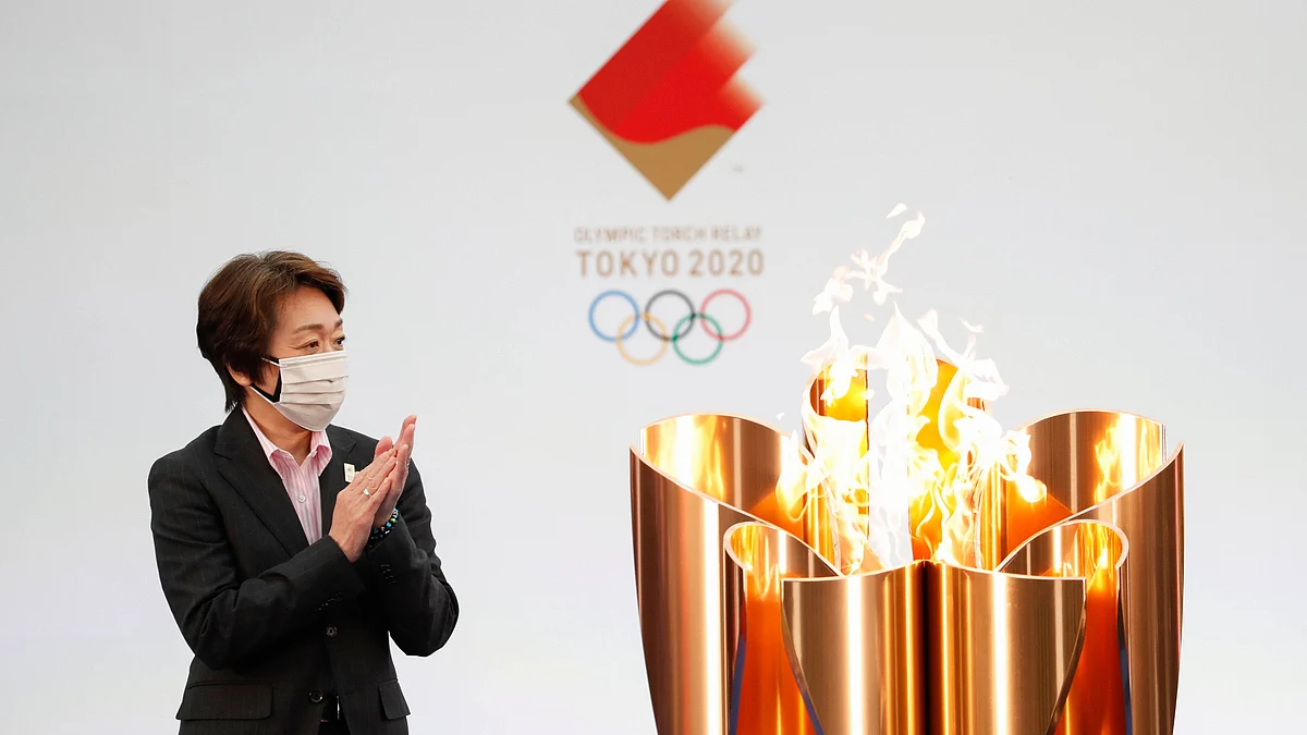 Tokyo 2020 Organizing Committee President Seiko Hashimoto applauds next to the celebration cauldron on the first day of the Tokyo 2020 Olympic torch relay in Naraha, Fukushima prefecture, northeastern Japan, Thursday, March 25, 2021.&nbsp;
