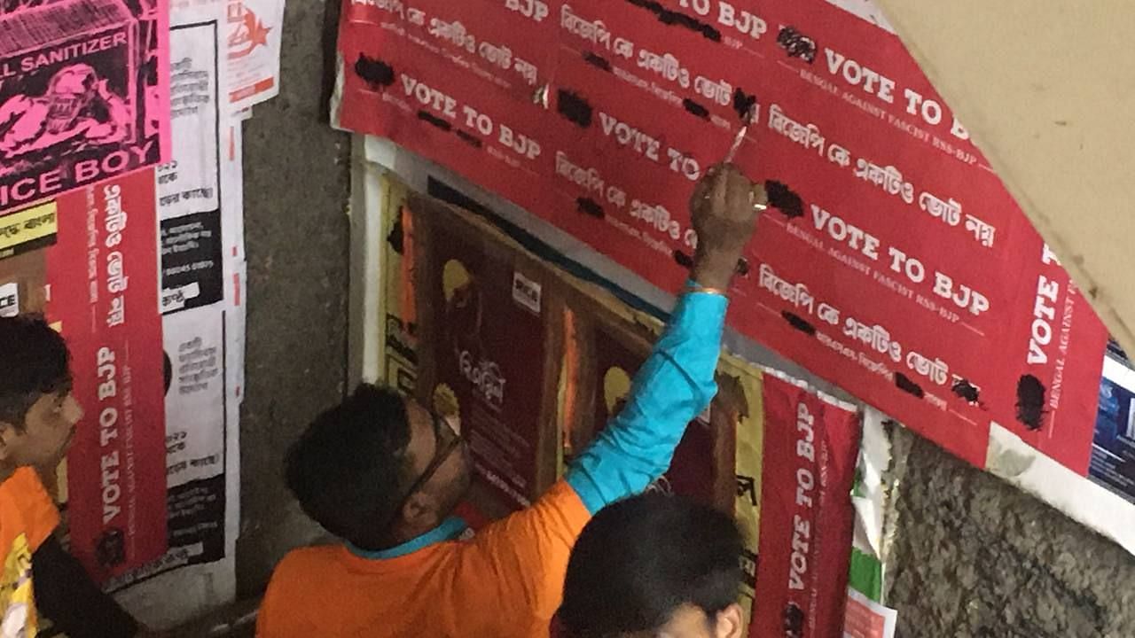 Alleged BJP goons painting over ‘No Vote to BJP’ posters.