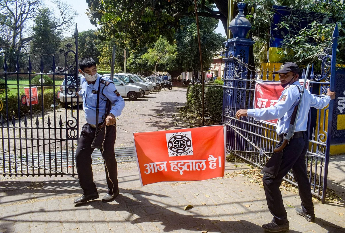 Security guards stand outside a closed Allahabad Bank during a nationwide strike, called by United Forum of Bank Unions (UFBU), to protest against the proposed privatisation of two state-owned lenders, in Prayagraj.