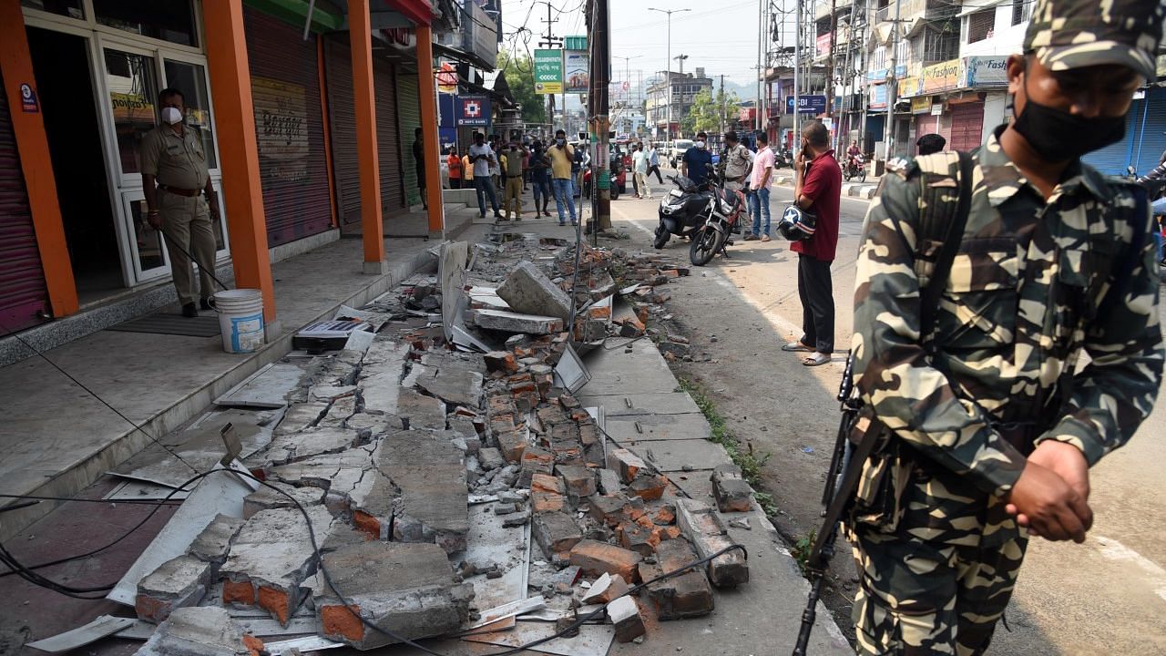 Security personnel stand guard near a building in Guwahati, Assam, that was damaged in an earthquake of a magnitude of 6.4 on the Richter Scale at 7:51 am on Wednesday, 28 April. The epicentre of the quake was 43 km west of Tezpur.