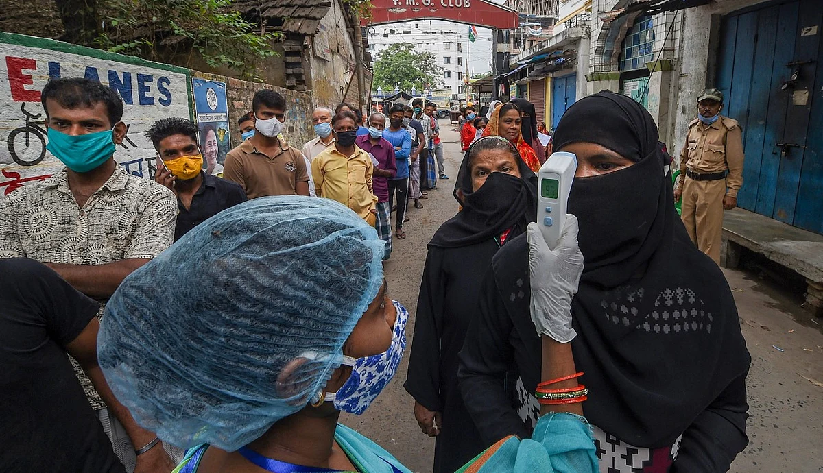 Voters stand a queue at a polling station during the sixth phase of West Bengal Assembly elections, of Barrackpur assembly seat in North 24 Parganas district