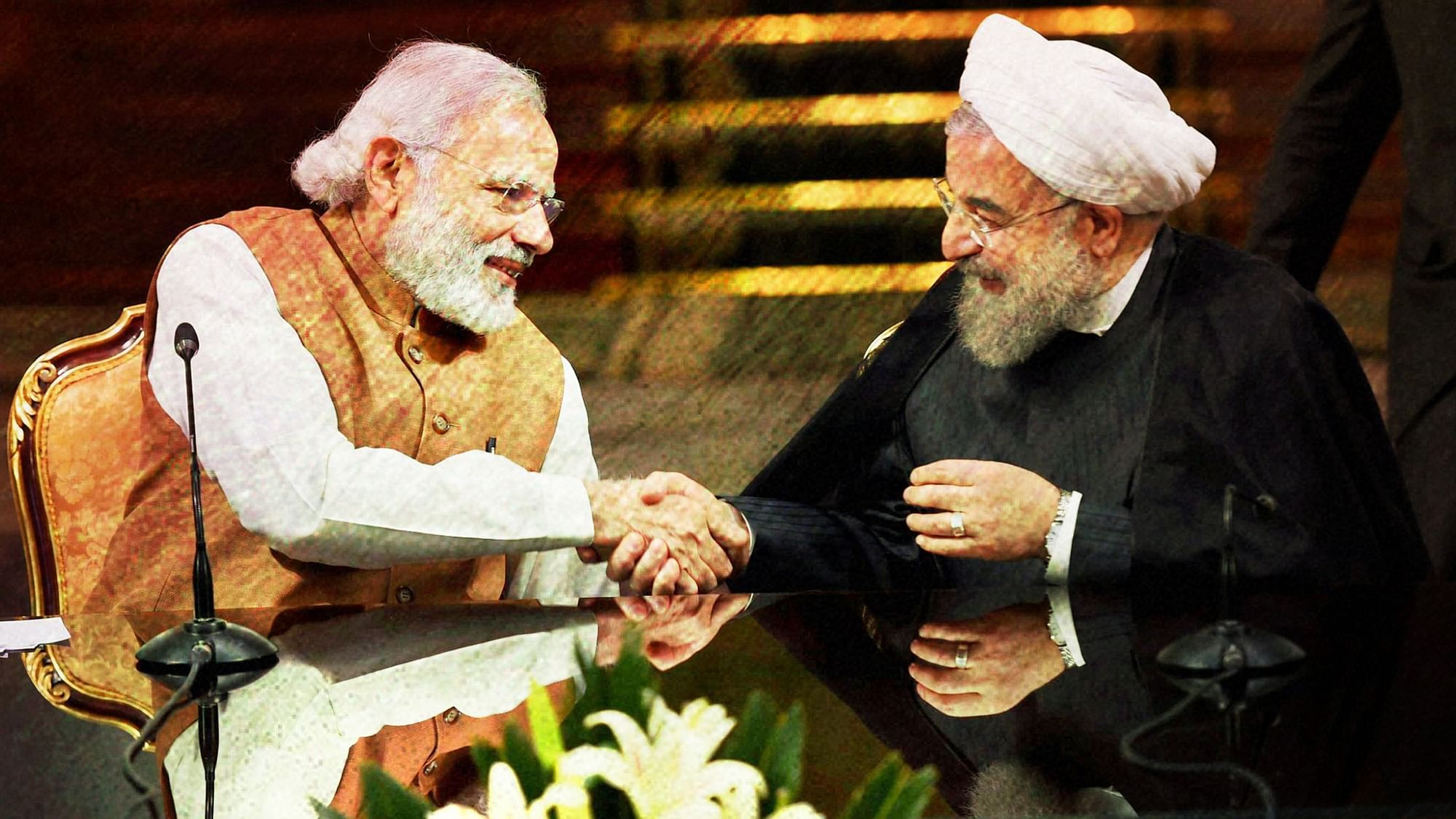 Prime Minister Narendra Modi shakes hands with Iranian President Hassan Rouhani.