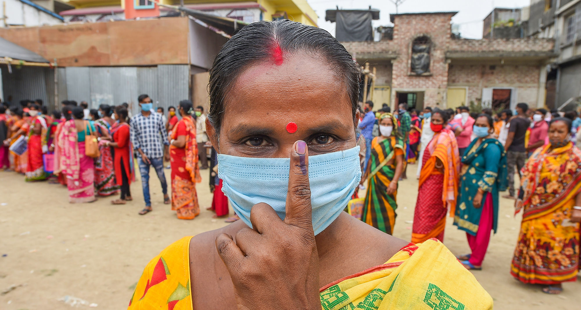 A voter shows her inked finger after casting her vote at a polling station during the 6th phase of West Bengal State Assembly Elections at Khardha, in North 24 Parganas, Thursday, 22 April 2021.&nbsp;