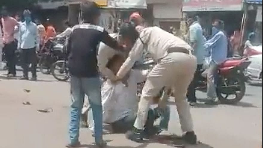 A screengrab from a video that captured the 35-year-old man being beaten up by the police in Indore on Tuesday.