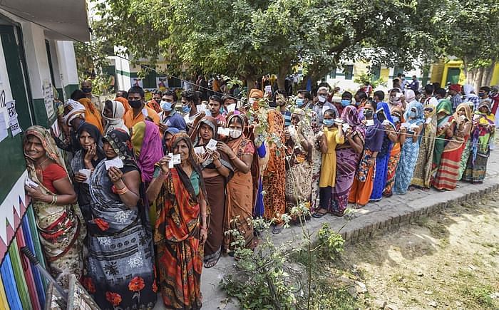 Visuals showed voters, many without masks, standing in packed queues at the polling stations.