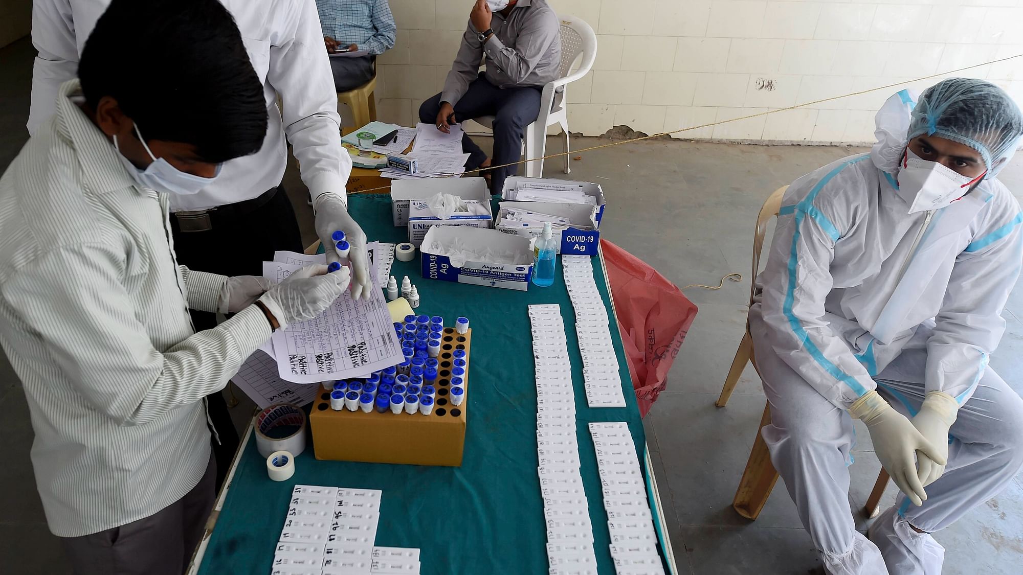 A health worker sort swab samples at a testing centre, as coronavirus cases surge across the national capital, at MCD dispensary, Mehrauli, in New Delhi.