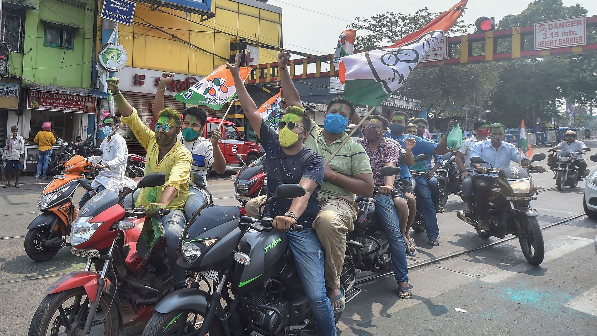 TMC activists celebrate winning trend in the West Bengal state assembly elections, in Kolkata, Sunday, 2 May.
