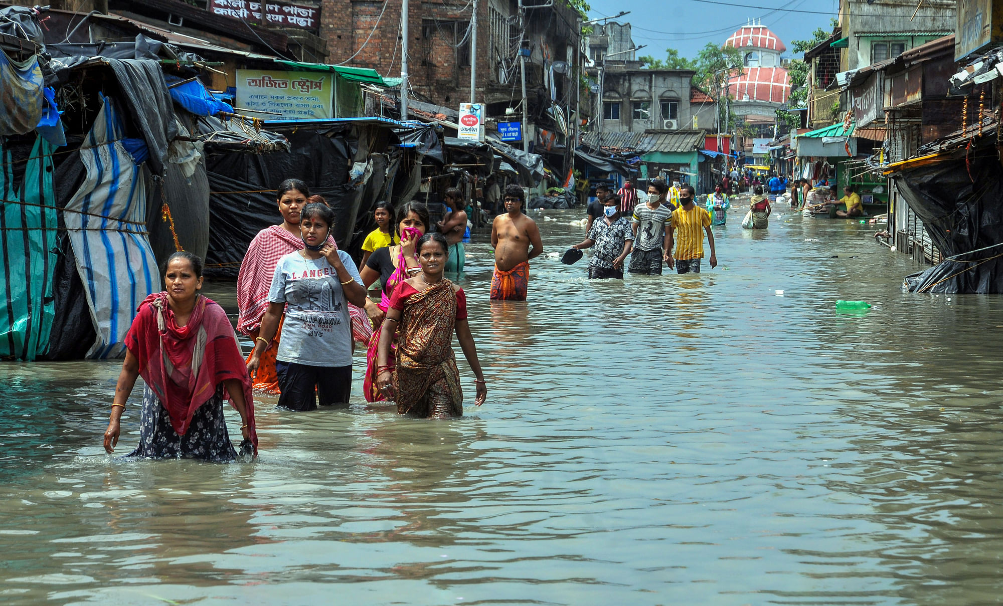Pedestrians wade through a flooded road in Kolkata as Cyclone Yaas made landfall.