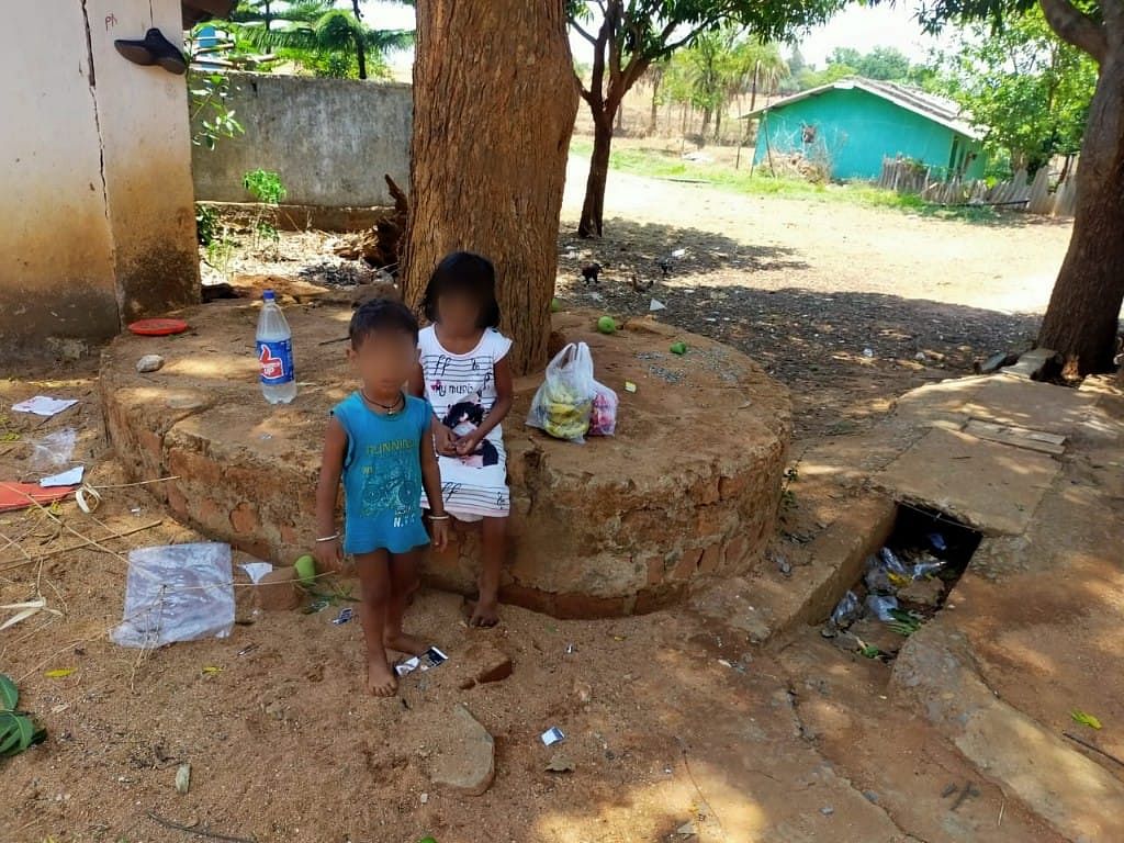 The two kids who lost their parents overnight cry, as fear of COVID stopped other villagers from reaching out to them.