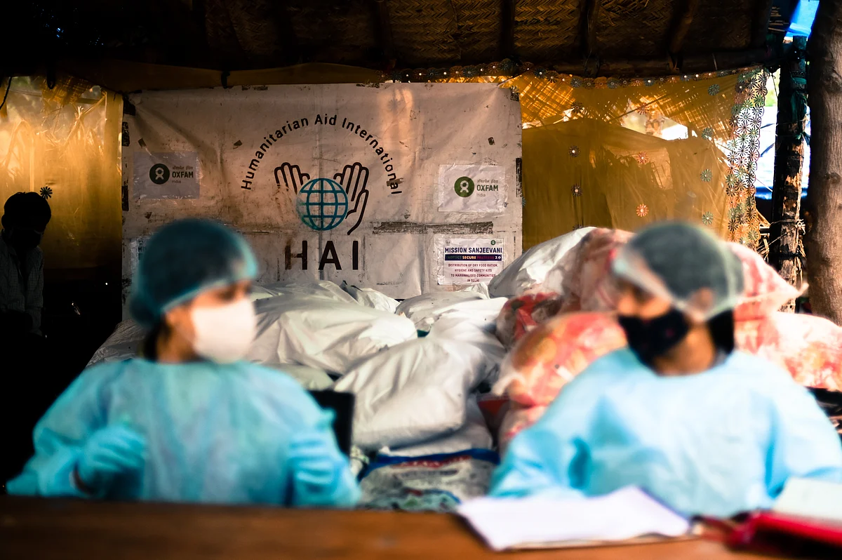 Aid workers from HAI work at a distribution facility in the Signature bridge refugee settlement in North Delhi.