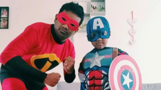 Son and father in UK dress as Superheroes while doing community service.