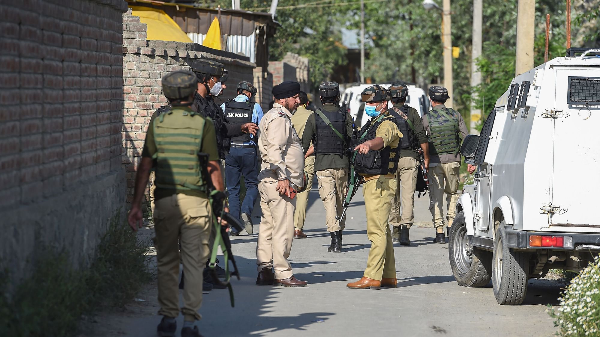 Security personnel during the ongoing encounter with militants, at Malhoora on the outskirts of Srinagar, Monday, 28 June 2021.