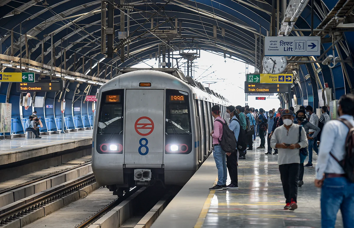 Commuters wait to board a train at the Lakshmi Nagar Metro Station after resumption of the Delhi Metro services in a graded manner, in New Delhi.