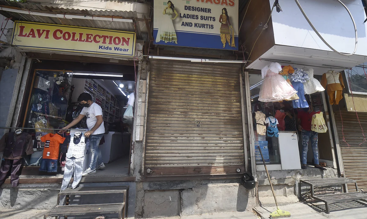New Delhi: A worker arranges clothes outside a shop after further ease in the COVID-19 lockdown, in New Delhi.