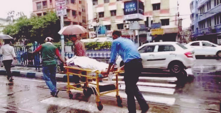 Patient shifted on stretcher amid heavy rains in Kolkata.