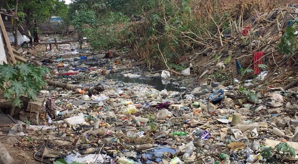 <div class="paragraphs"><p>A sewage stream, overflowing with garbage, flows adjacent to their homes.</p></div>
